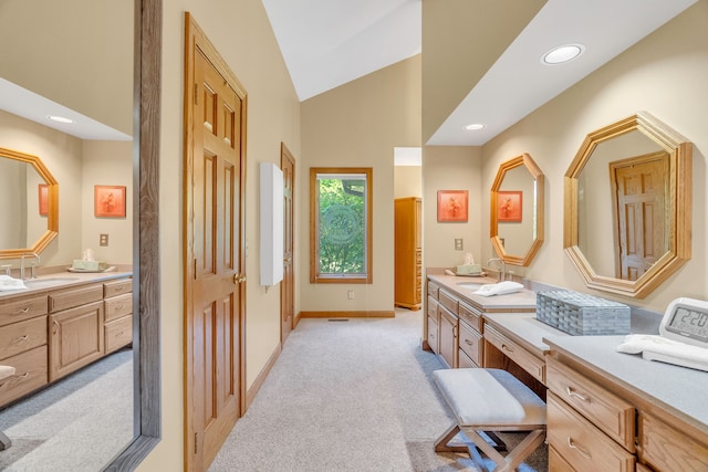 bathroom with vanity and high vaulted ceiling