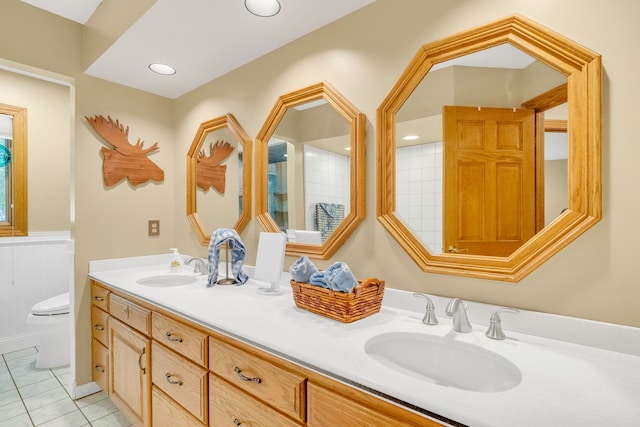 bathroom featuring tile patterned flooring, vanity, and toilet