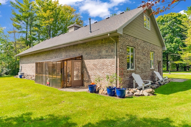 rear view of property with a lawn