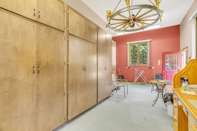 miscellaneous room featuring an inviting chandelier