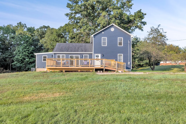 back of property featuring a lawn and a deck