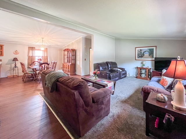 living room with wood-type flooring, crown molding, and lofted ceiling