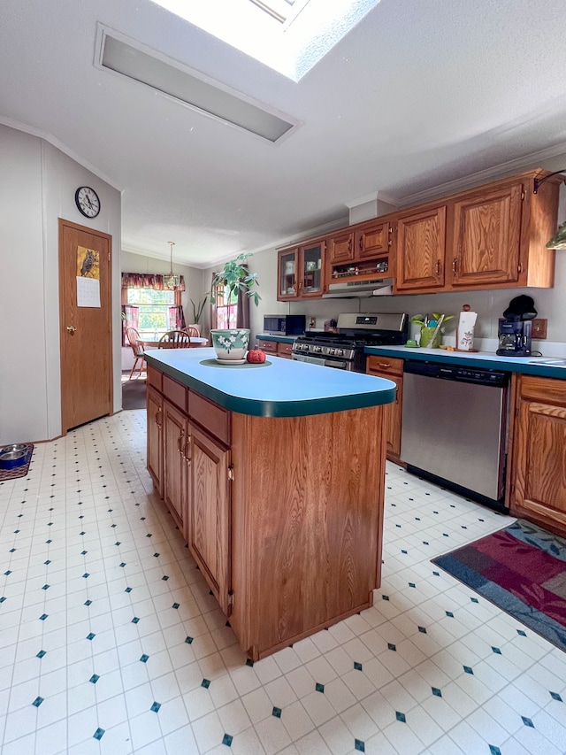 kitchen featuring a skylight, stainless steel appliances, pendant lighting, light tile patterned floors, and a center island