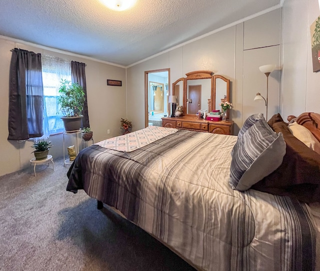 carpeted bedroom featuring lofted ceiling, a textured ceiling, ensuite bath, and crown molding