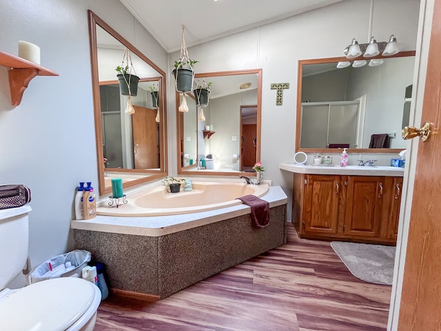 full bathroom with crown molding, hardwood / wood-style floors, toilet, vanity, and independent shower and bath