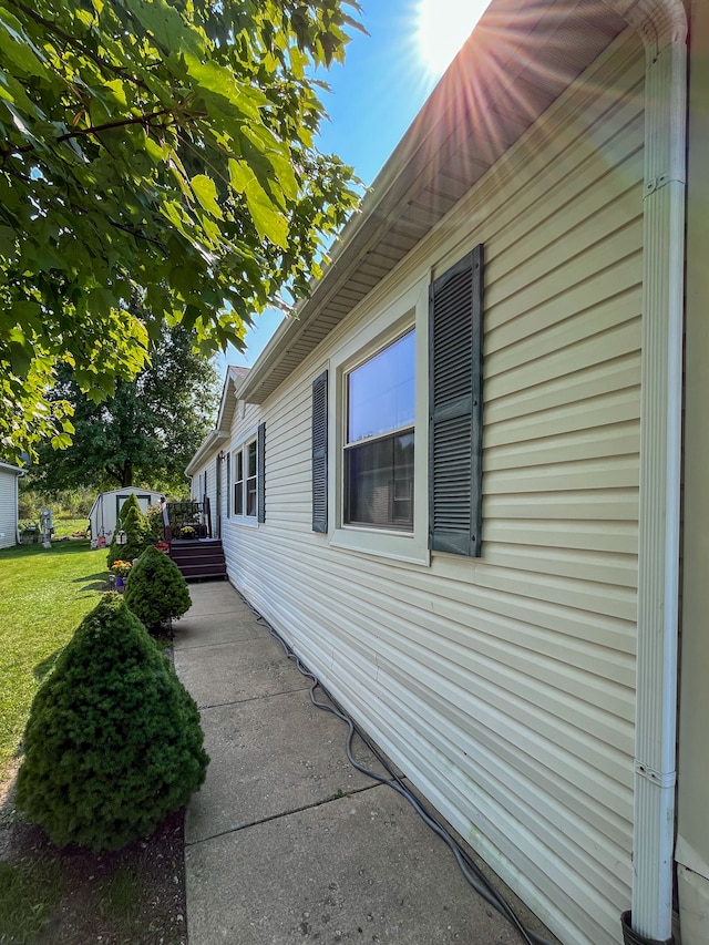 view of side of property with a lawn