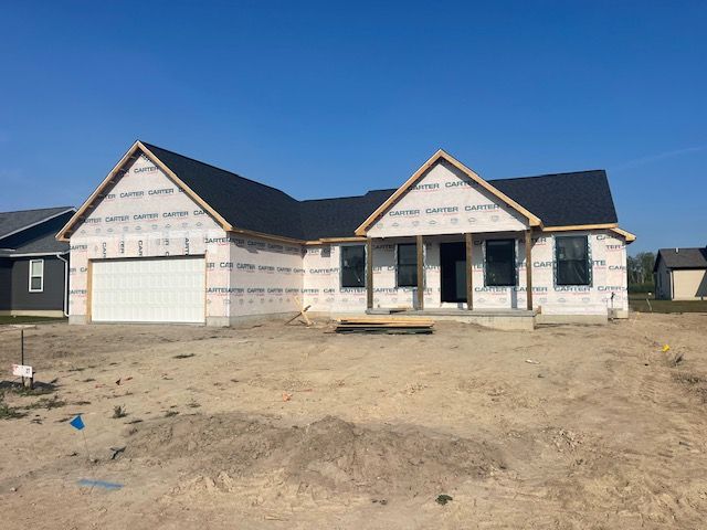 property under construction featuring a porch and a garage