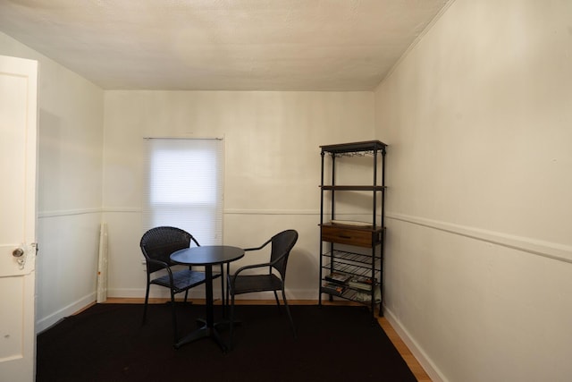 dining space featuring baseboards and wood finished floors