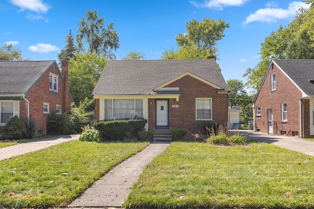 bungalow-style house with a front lawn