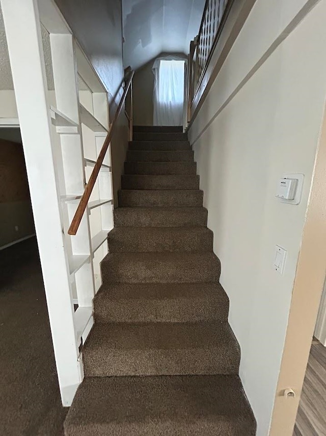 staircase with lofted ceiling