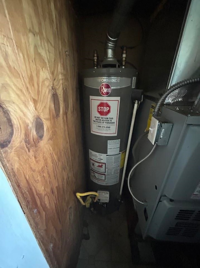 utility room featuring water heater