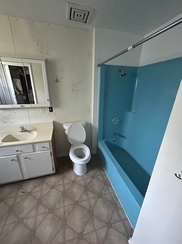 full bathroom with shower / tub combination, vanity, and toilet