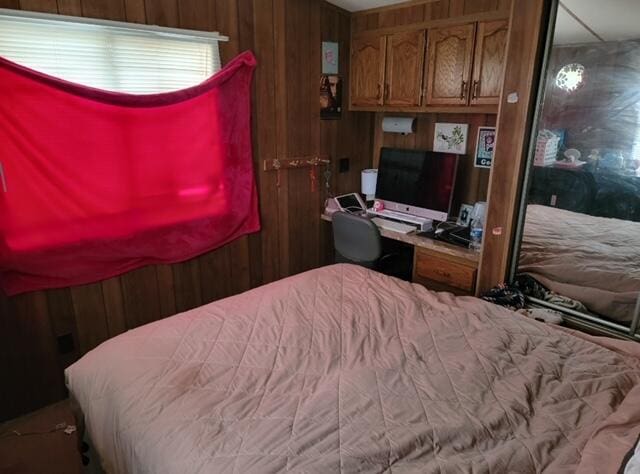 bedroom featuring wooden walls