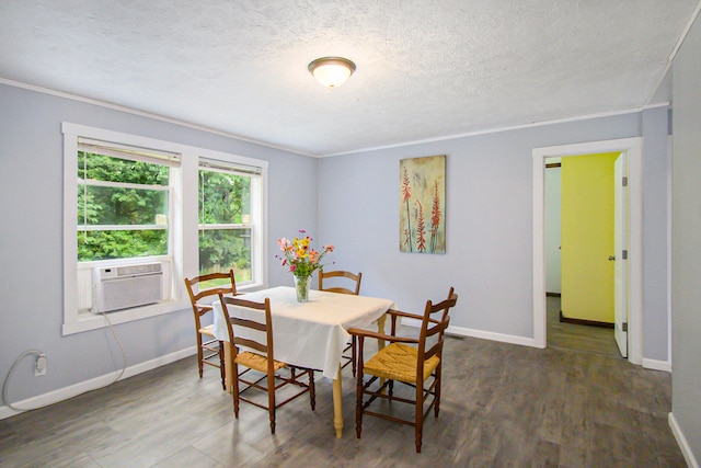 dining space with ornamental molding, a textured ceiling, cooling unit, and dark wood-type flooring