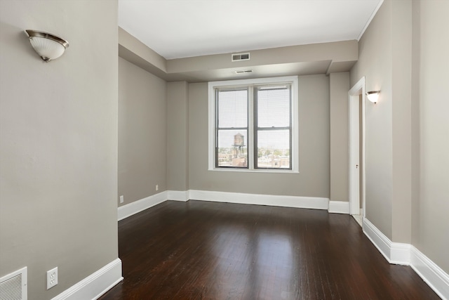 unfurnished room featuring dark wood-type flooring