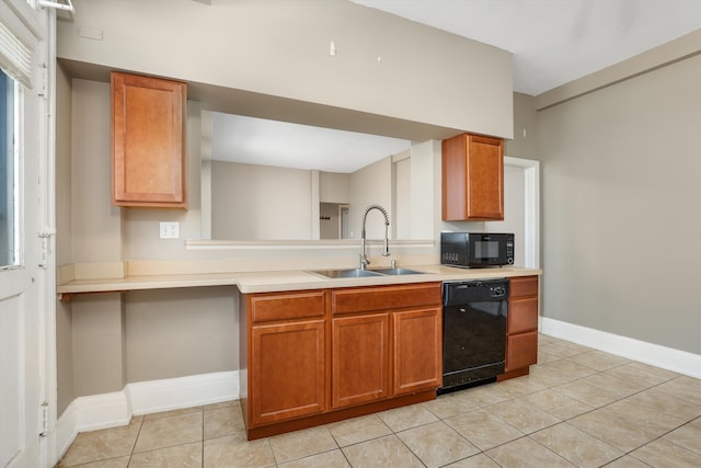 kitchen featuring black appliances, light tile patterned floors, and sink