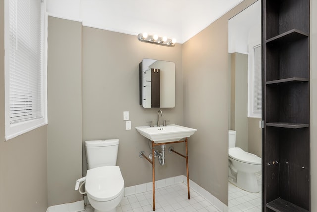 bathroom with tile patterned floors, sink, and toilet