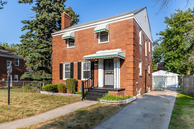 view of front of house with a front lawn, an outdoor structure, and a garage