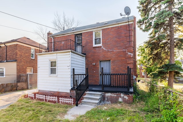 rear view of house featuring a balcony