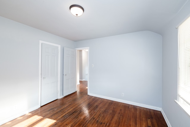 unfurnished bedroom with dark hardwood / wood-style flooring