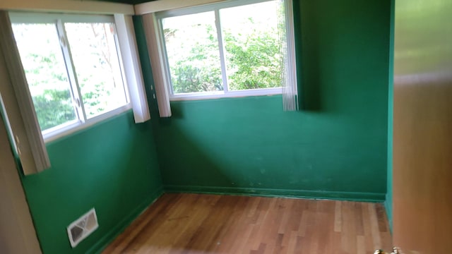 empty room with hardwood / wood-style flooring