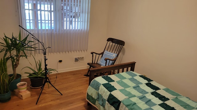 bedroom with hardwood / wood-style floors