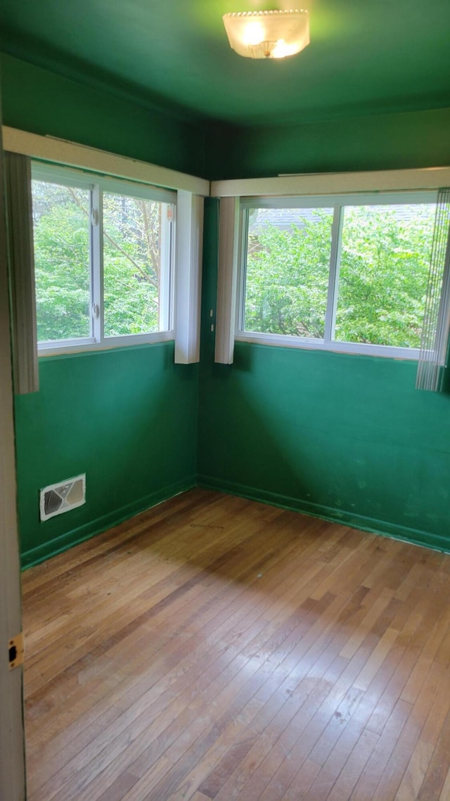 unfurnished room with a wealth of natural light and light wood-type flooring