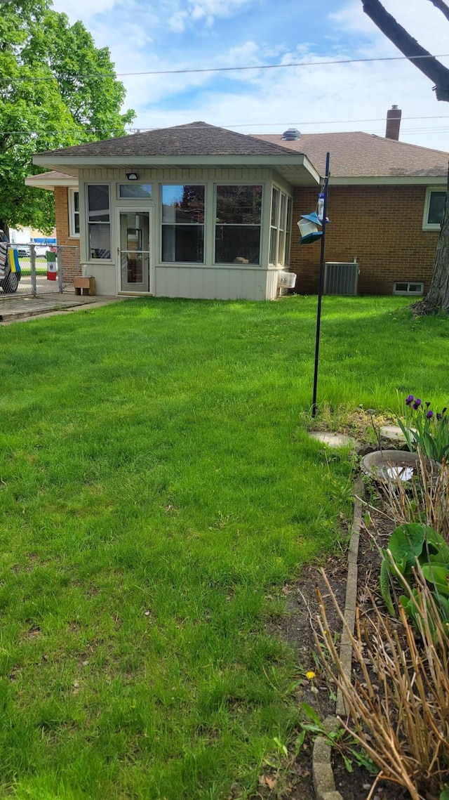 rear view of house with a yard