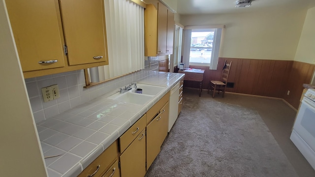 kitchen featuring light carpet, backsplash, white range oven, sink, and tile countertops