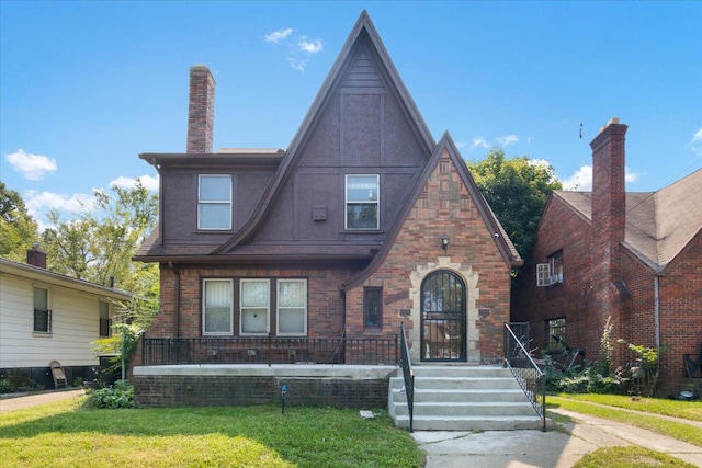 tudor home featuring a front yard