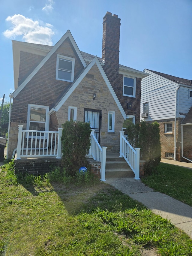 view of front of house with a porch and a front yard