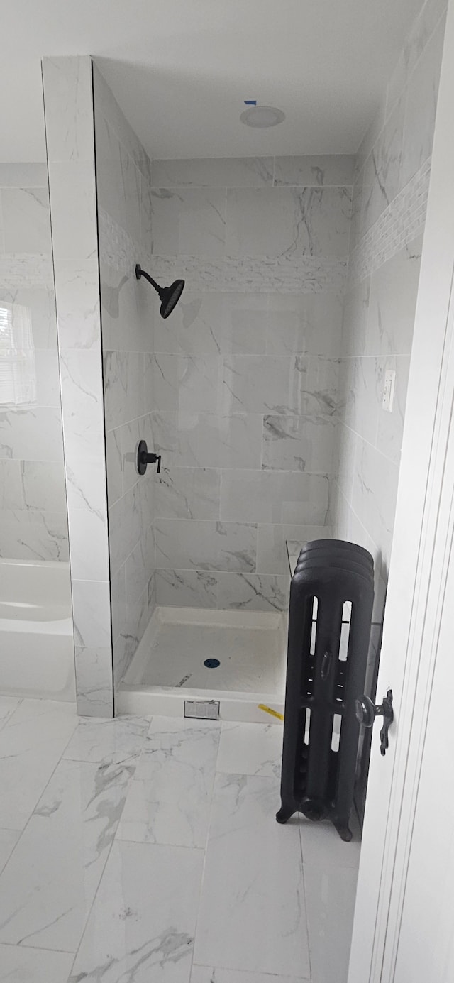 bathroom with a tile shower