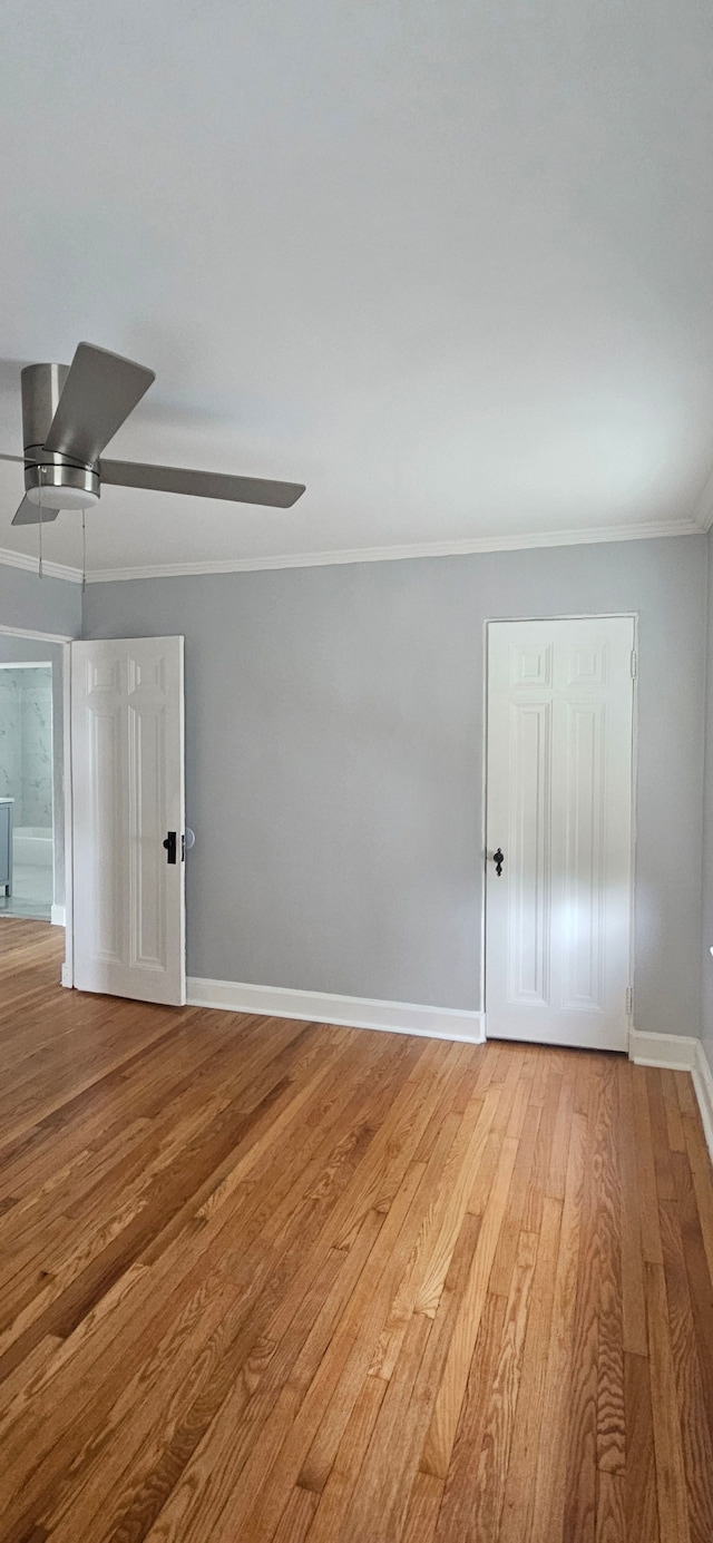 unfurnished room with ceiling fan, ornamental molding, and hardwood / wood-style flooring