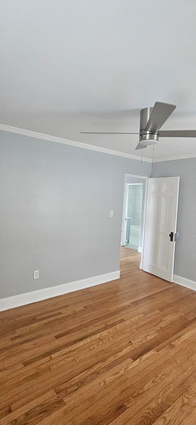 unfurnished room with hardwood / wood-style floors and crown molding