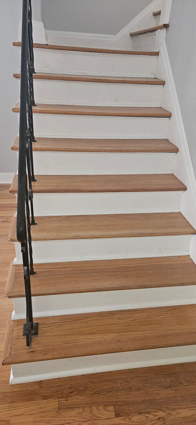 stairs featuring wood-type flooring