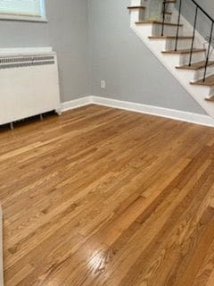 unfurnished dining area featuring radiator heating unit and wood-type flooring