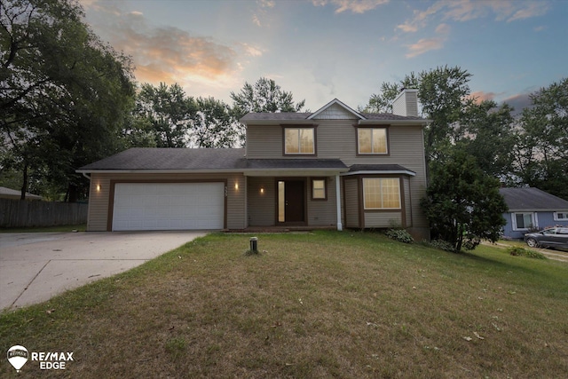 view of front facade featuring a garage and a lawn