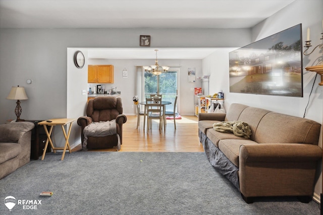 living room featuring wood-type flooring and an inviting chandelier