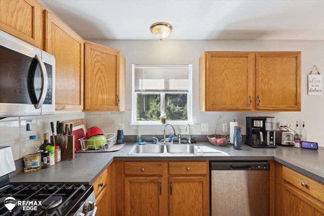 kitchen featuring appliances with stainless steel finishes, backsplash, and sink