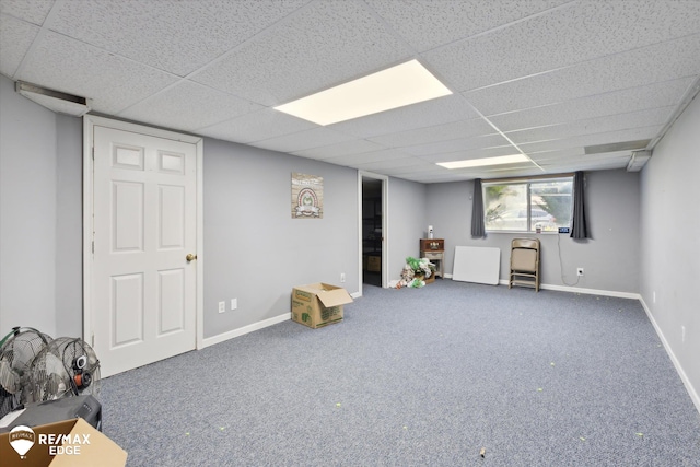 basement with a paneled ceiling