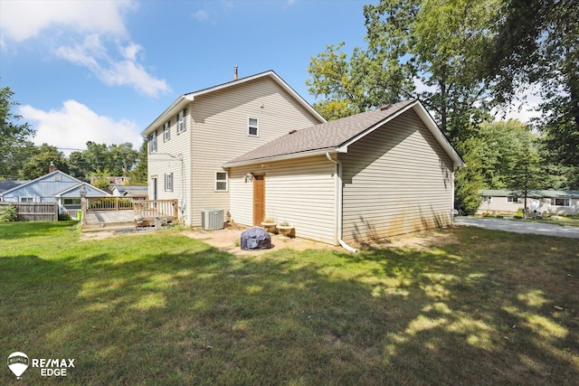 back of house with a lawn, a wooden deck, and cooling unit