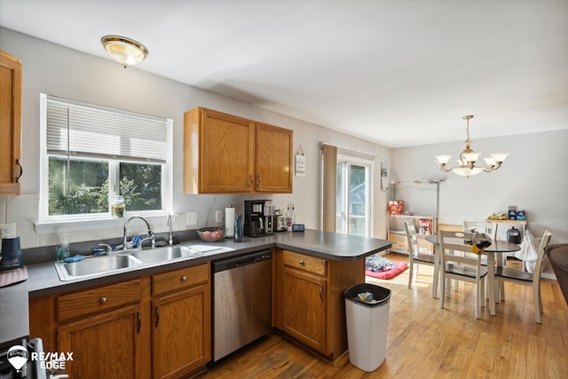 kitchen with sink, light hardwood / wood-style flooring, stainless steel dishwasher, decorative light fixtures, and kitchen peninsula