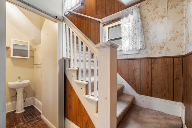 staircase with wood walls