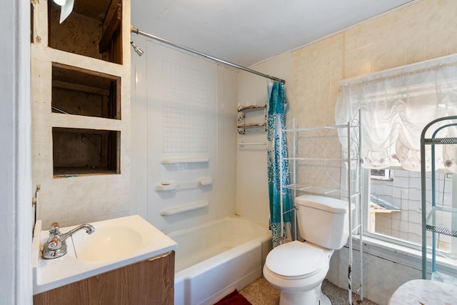 full bathroom featuring vanity, shower / bath combo, toilet, and tile walls