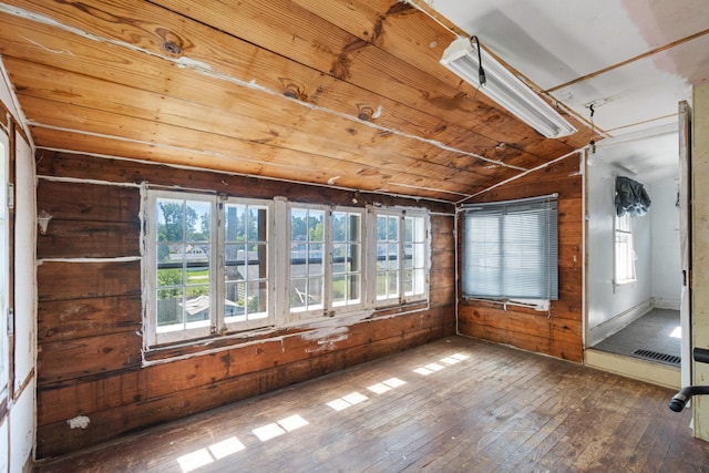 unfurnished sunroom featuring vaulted ceiling