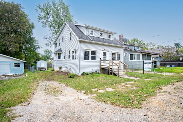 view of front facade with an outdoor structure and a front lawn