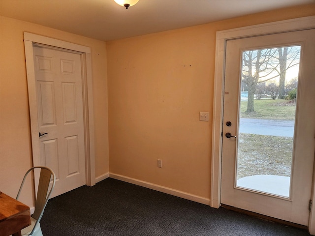 entryway with dark colored carpet