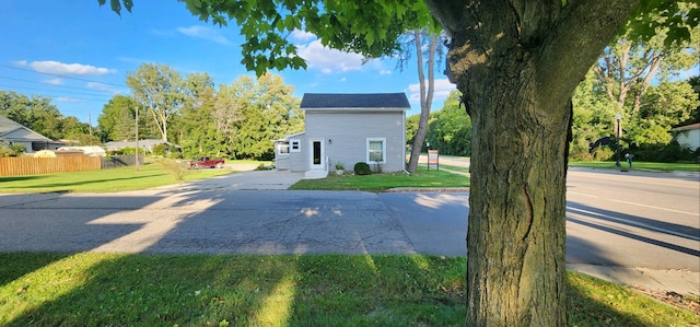 view of home's exterior with a patio area and a lawn