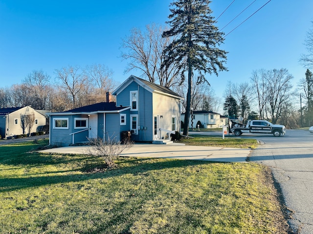 back of property featuring a lawn