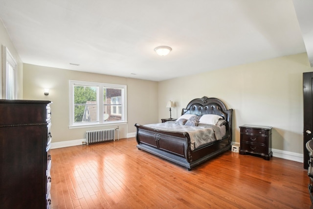 bedroom featuring wood-type flooring and radiator